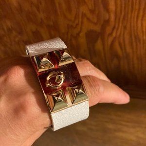 Gold tone and white vegan leather adjustable band bracelet with snaps